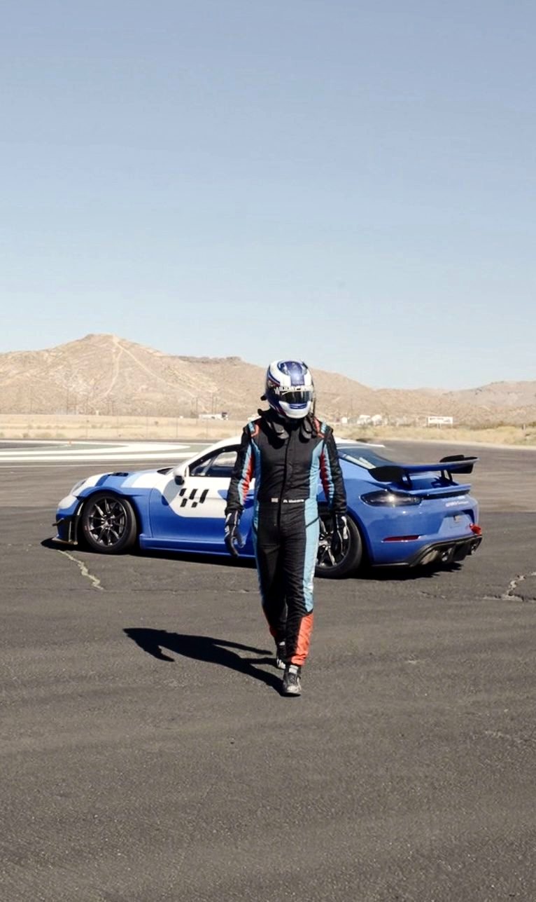 Alex Waters walking away from a Porsche 718 GT4 at Willow Springs