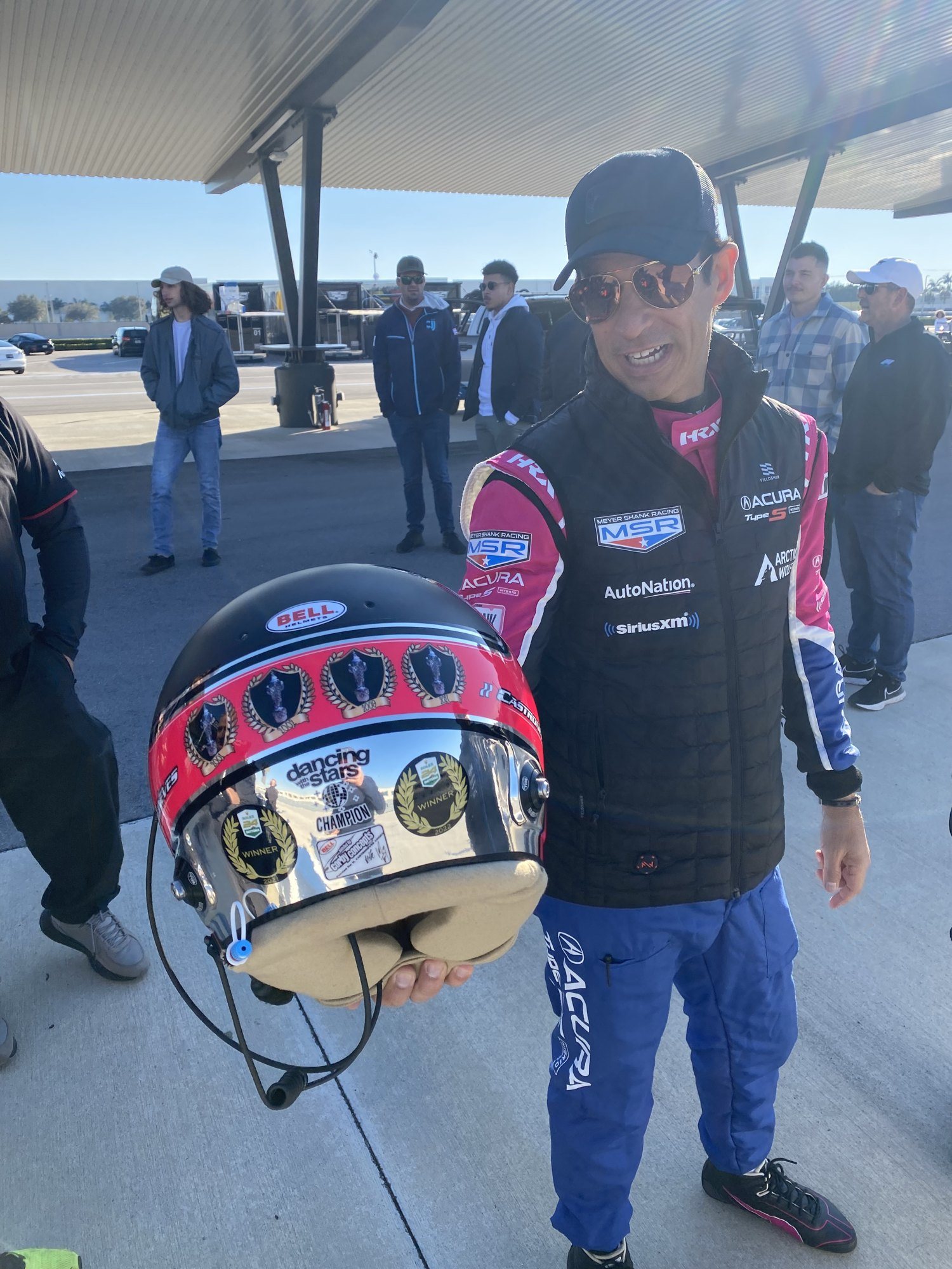 Pit lane with an IndyCar driver and a Bell helmet