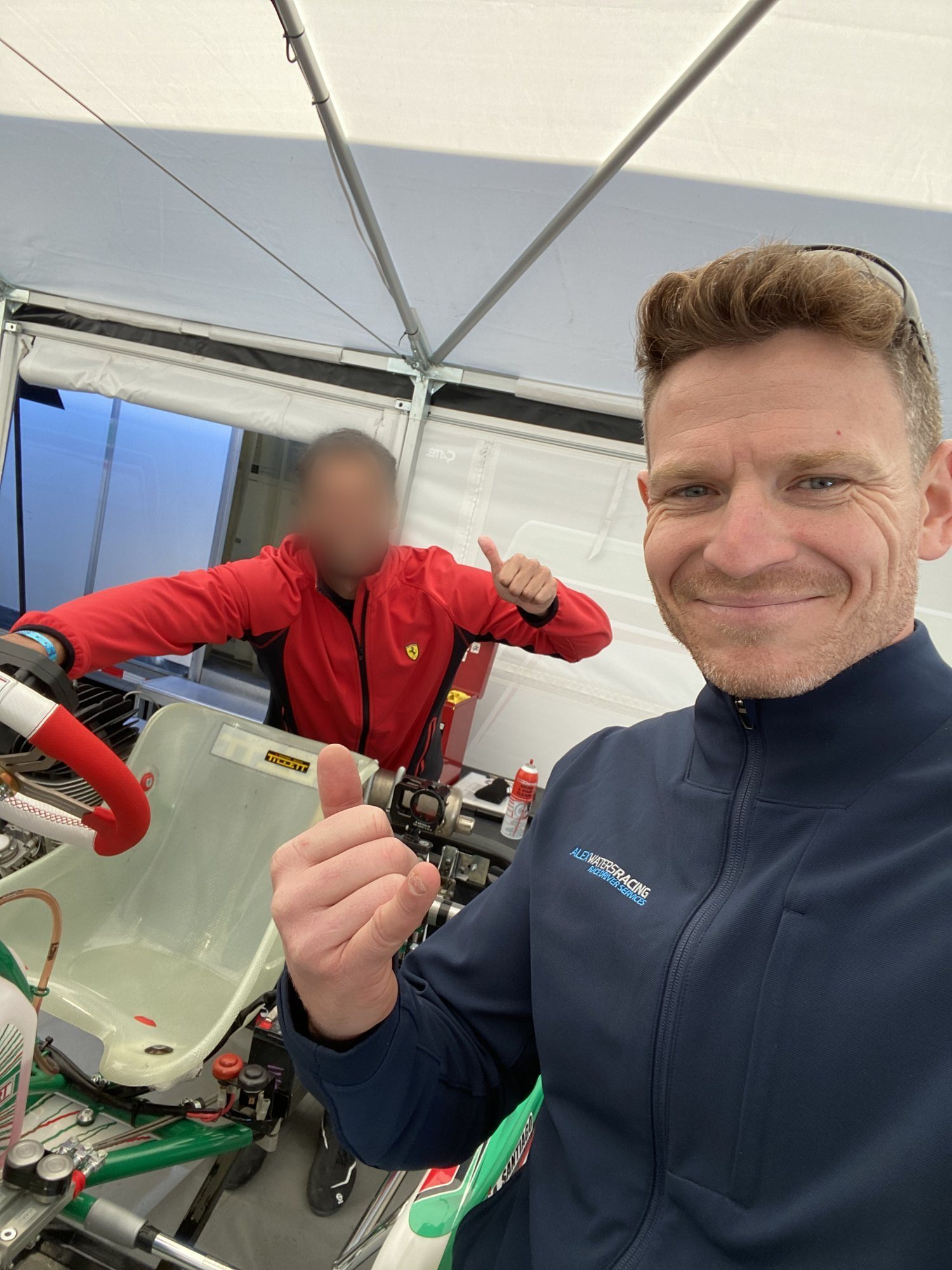 Alex Waters with a karting driver in the awning