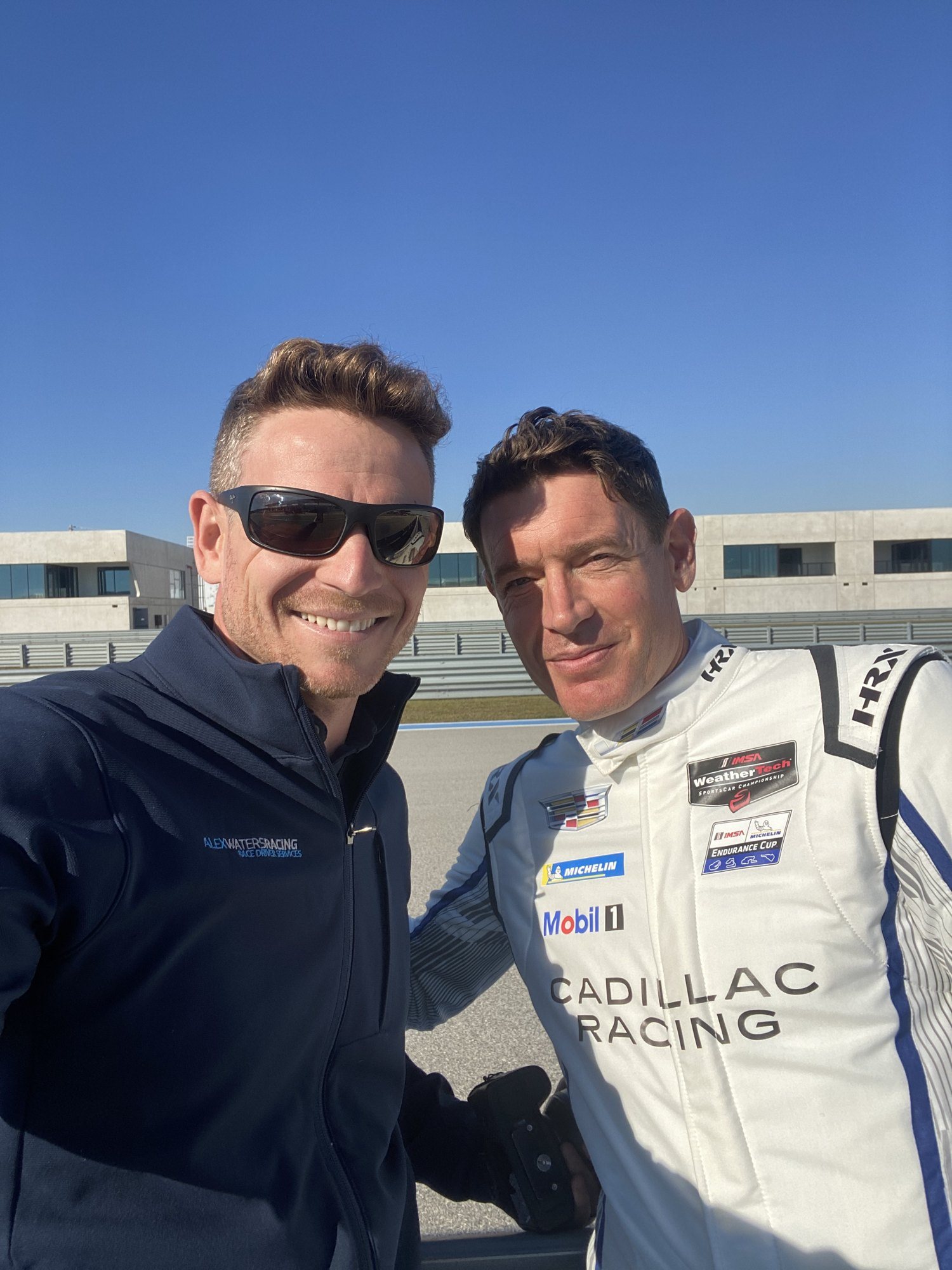 Alex Waters trackside with a Cadillac Racing driver