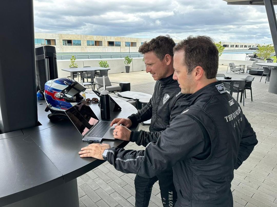 Alex Waters reviewing lap video with a client at The Concours Club