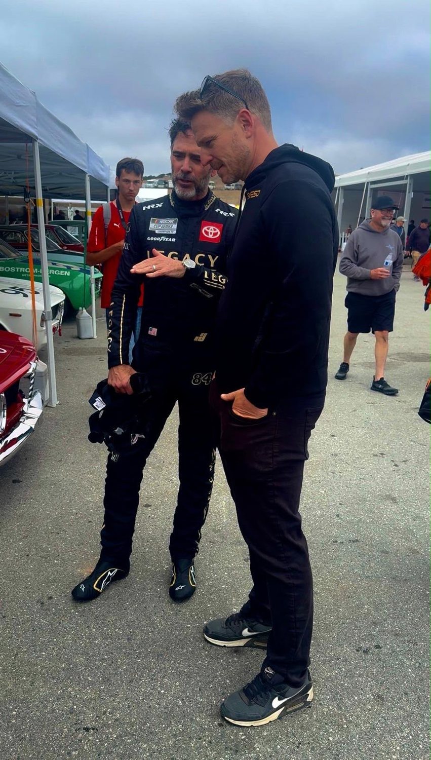 Alex Waters talking with Jimmie Johnson in the paddock at Laguna Seca
